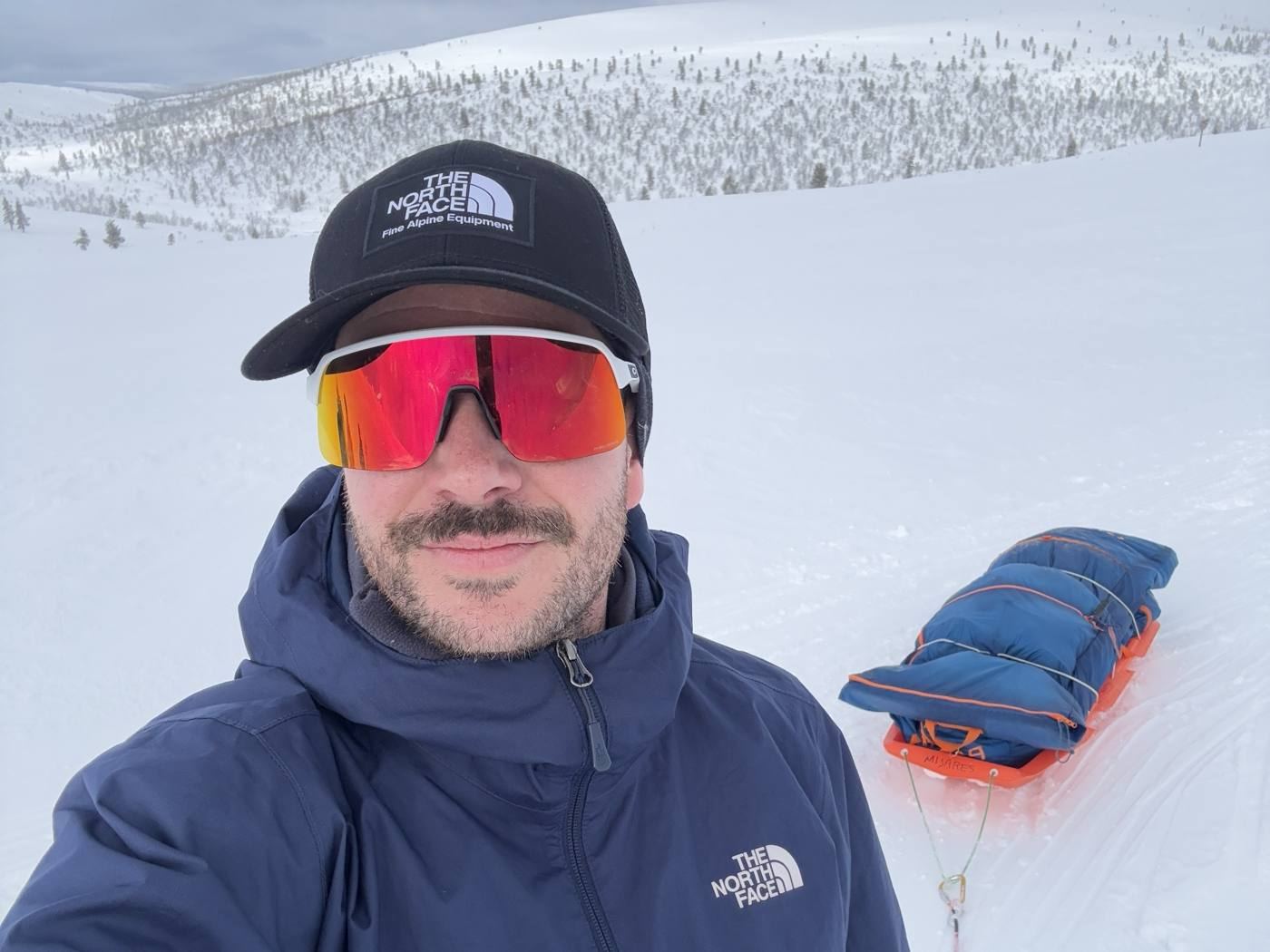 Carlos Torres pulling a pulk sled in Finnish Lapland